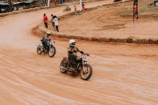 Riders compete in a thrilling vintage motorcycle dirt track race.