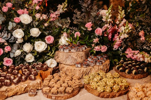 Various Kinds of Sweet on Table against Roses