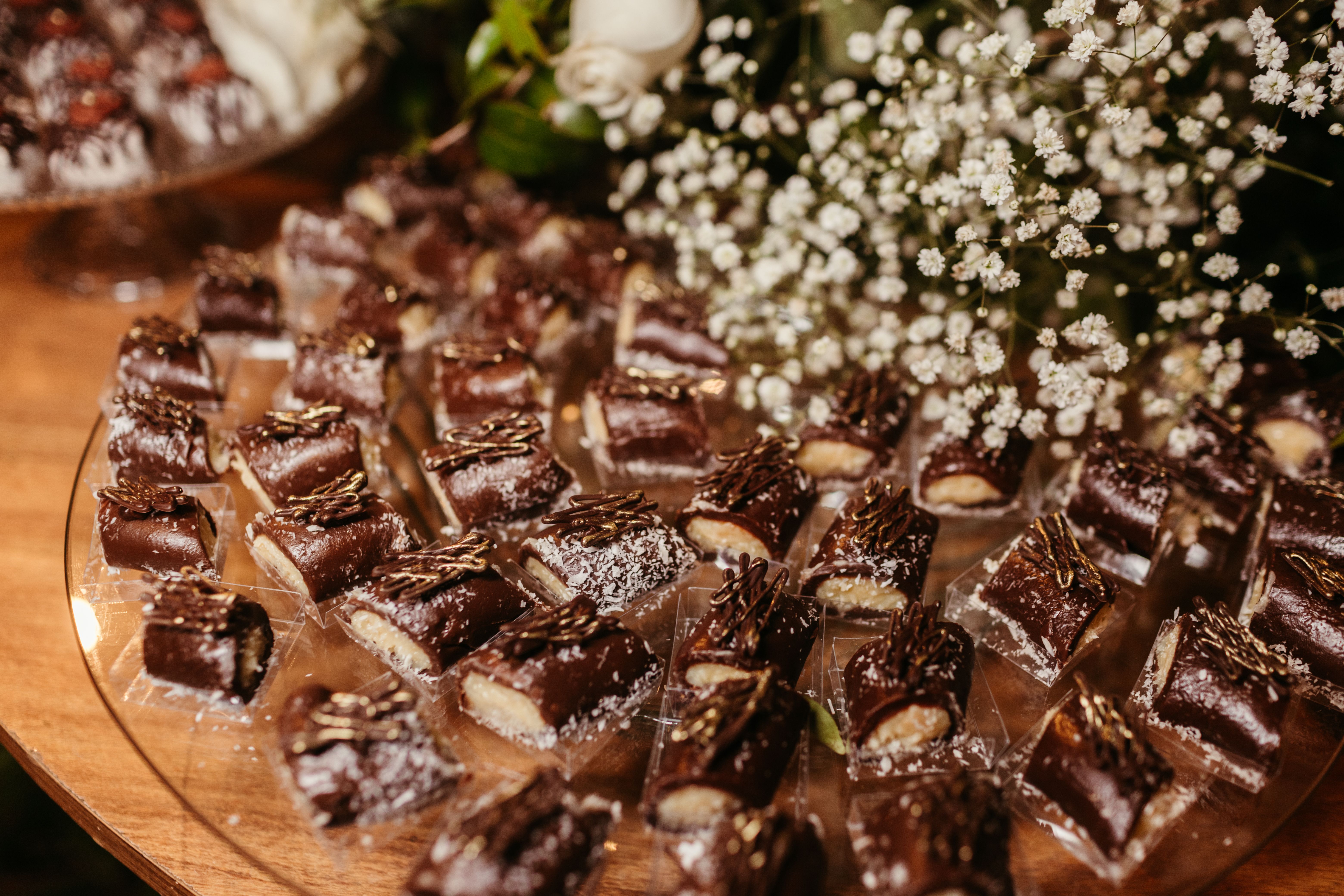 Assorted chocolates arranged elegantly with floral decor, perfect for weddings or receptions.