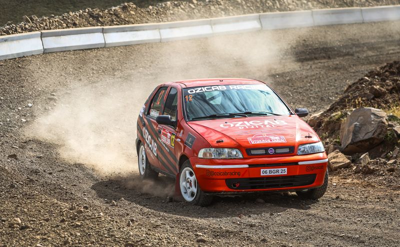 A red car driving on a dirt road · Free Stock Photo