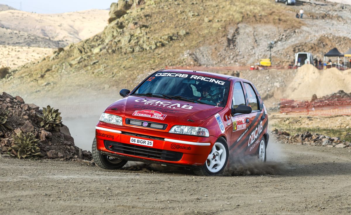 A red car driving on a dirt road · Free Stock Photo