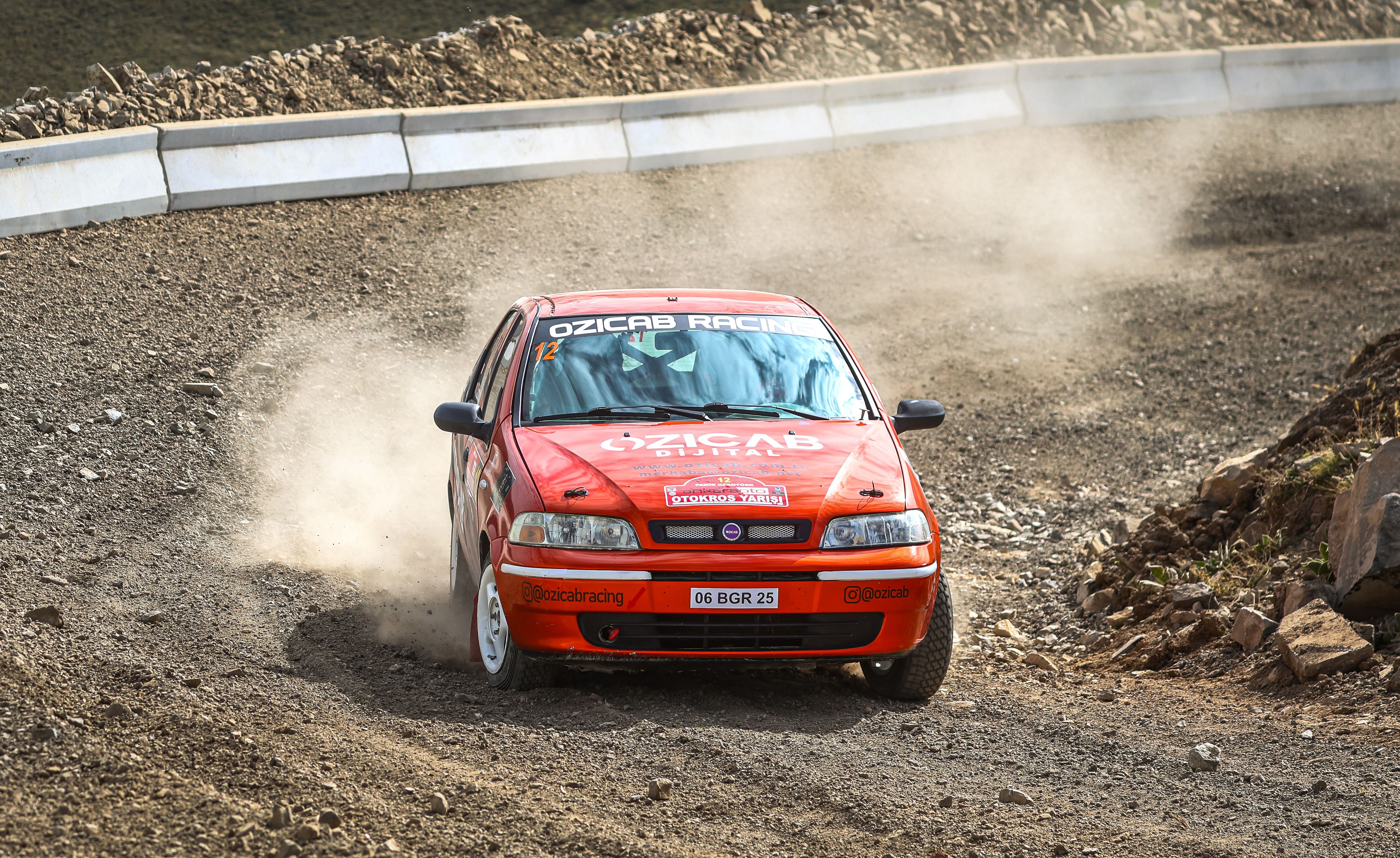 A red car driving on a dirt road · Free Stock Photo