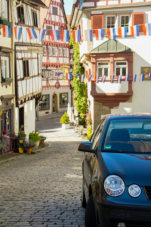 A Car Parked in an Alley with Historic Half Timbered Houses