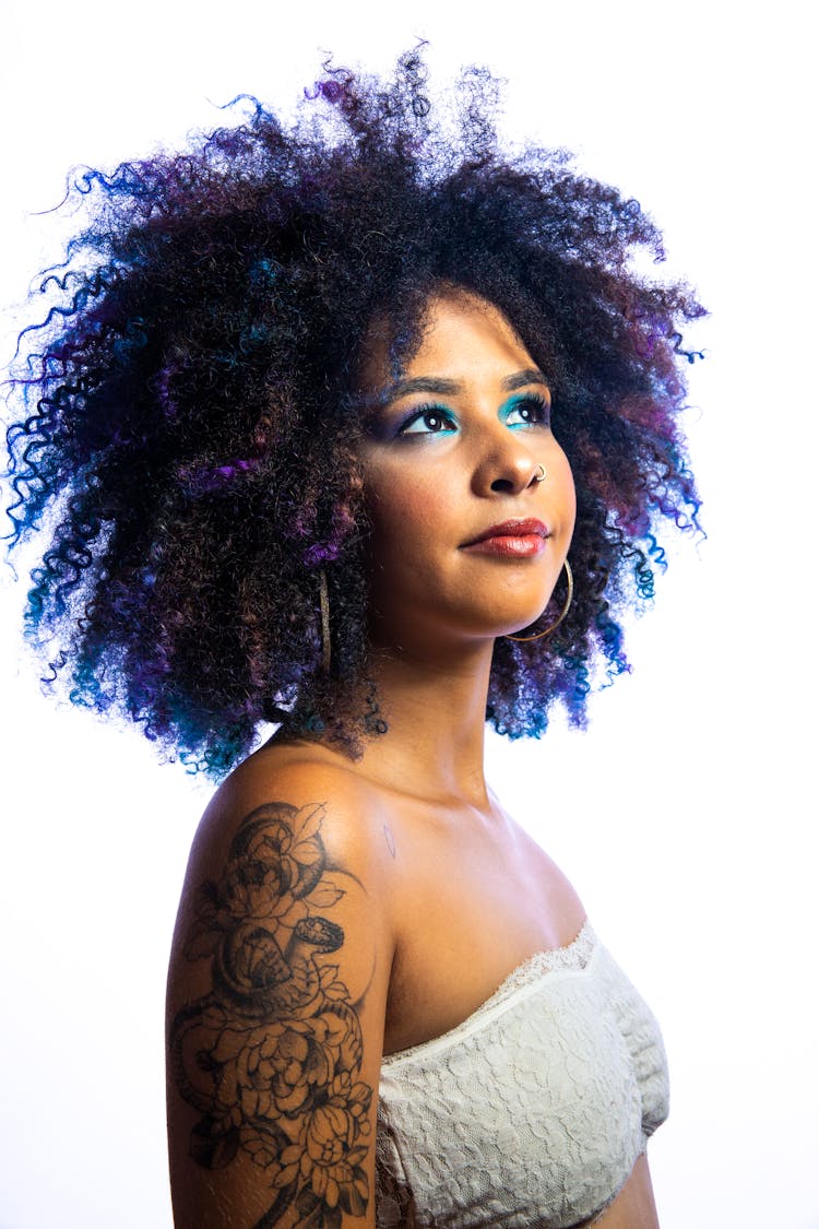 Portrait Of A Tattooed Female Model Wearing An Afro