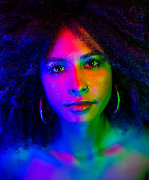 Portrait of a Pretty Brunette Covered in Colorful Lights