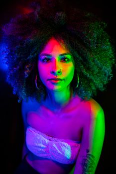 Colorful neon-lit portrait of a woman with afro hair in a white top, exuding a vibrant nightlife vibe.