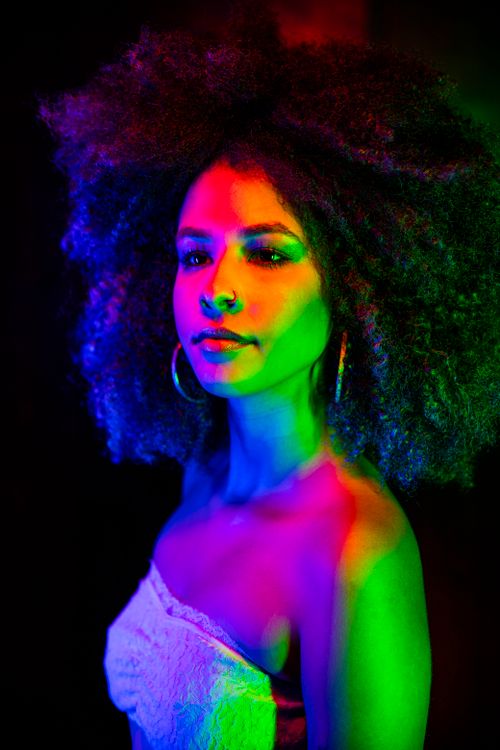 Portrait of a Female Model Covered in Colorful Lights · Free Stock Photo