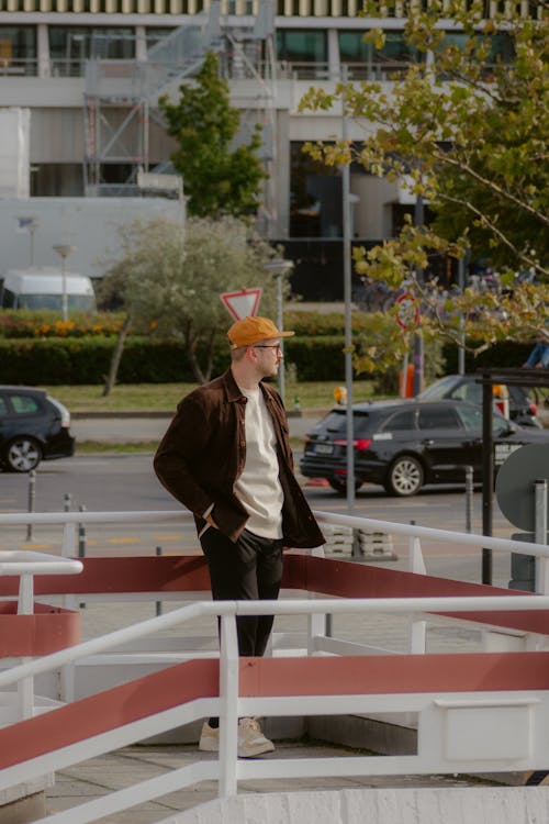 Man with Hands in Pockets next to Railing