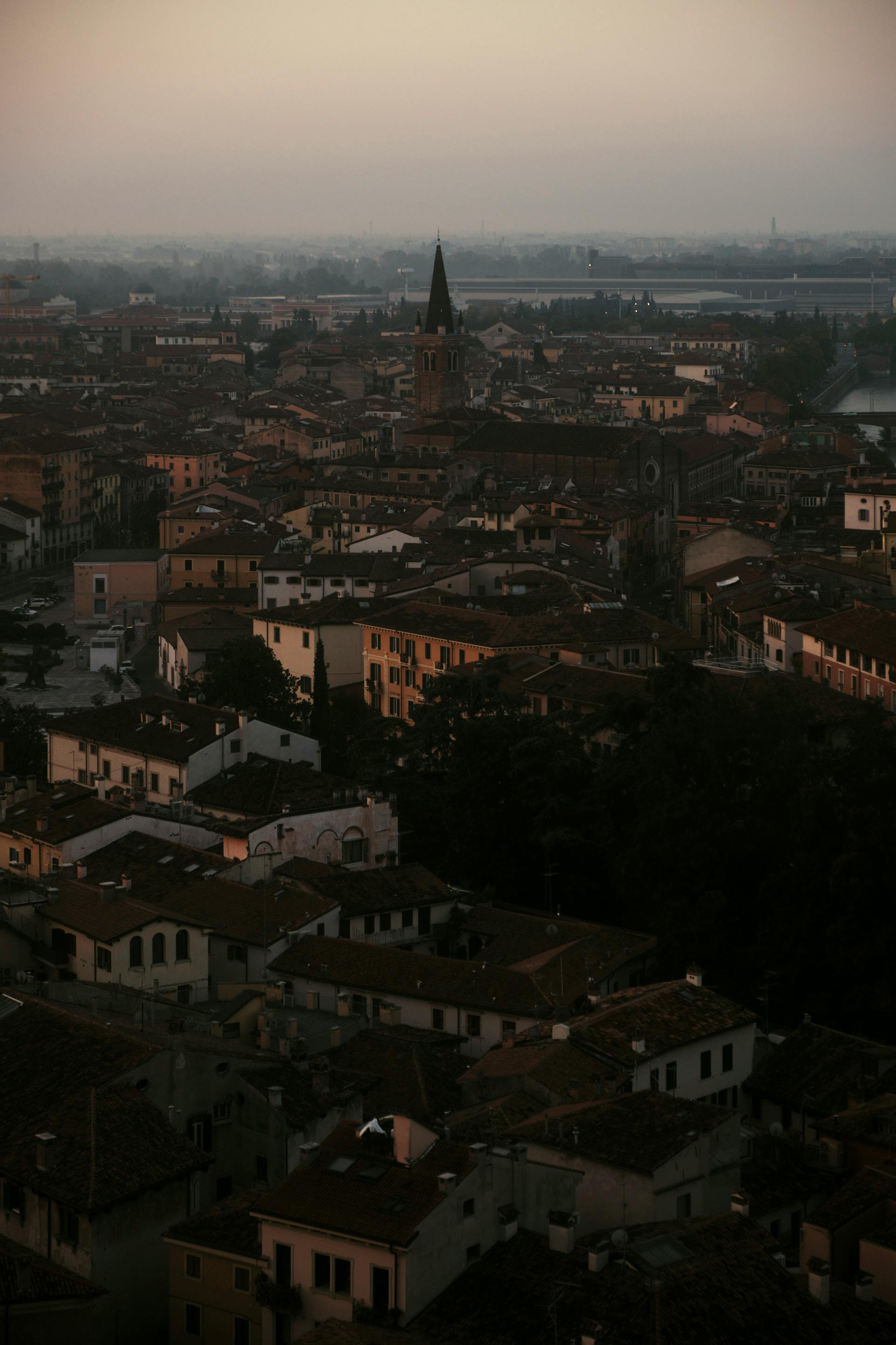 Captivating aerial shot of Verona's historic rooftops and architecture during the evening twilight.