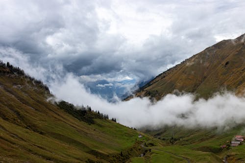 Landscape of a Mountains with Low Clouds Hanging above the Valley 