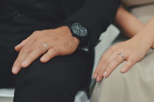 Free Close-up of couple's hands with wedding rings, symbolizing love and union. Stock Photo