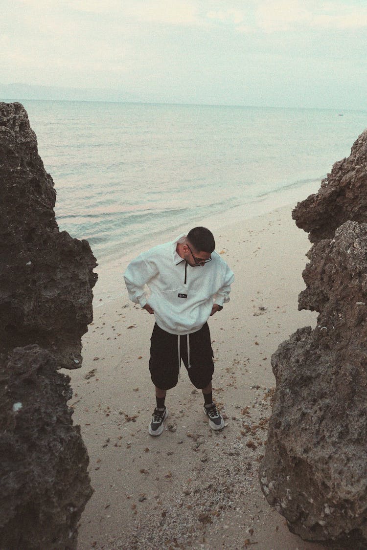 Man In A Sweatshirt Standing On A Beach