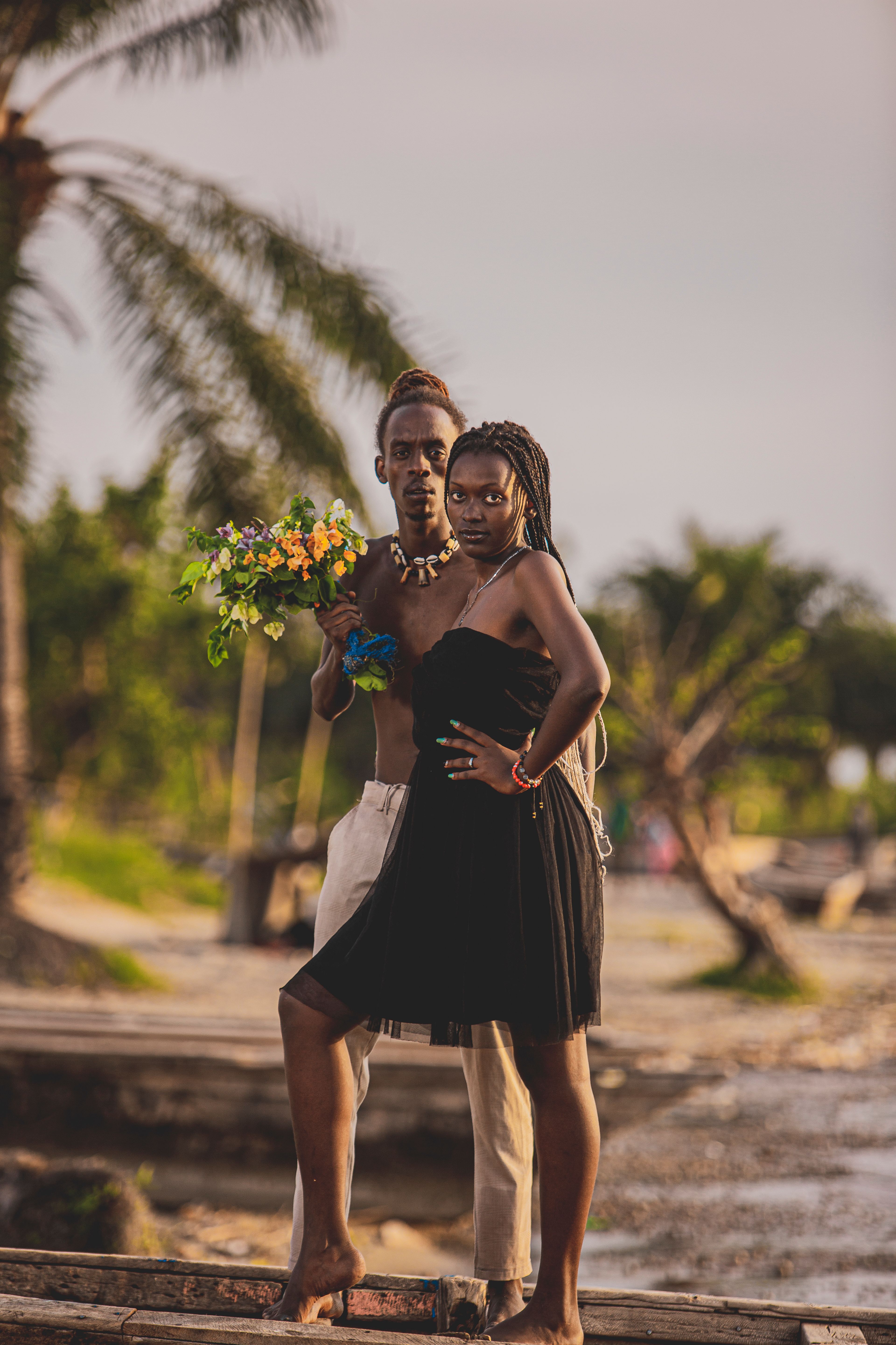 Woman in Black Dress and Man with Flowers in Bouquet  Free Stock Photo