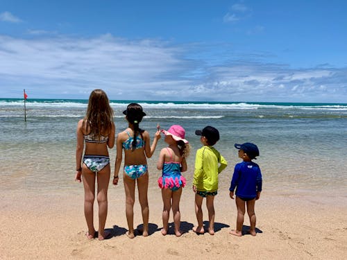 Children Stand on Beach and Look at Sea