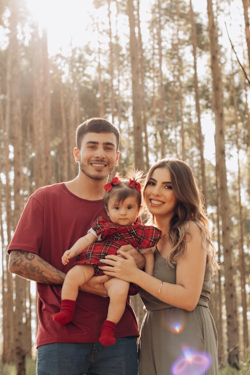 Portrait of Smiling Mother and Father with Baby Daughter