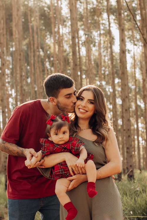 Mother and Father Standing with Baby Daughter