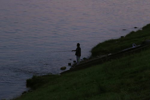 Silhouette of Man with a Fishing Rod 