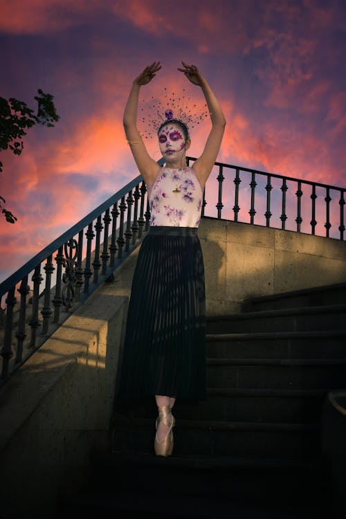 Catrina in Skirt Standing with Arms Raised
