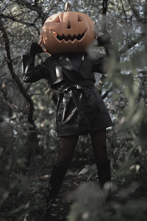 Woman Wearing a Carved Pumpkin on Her Head 