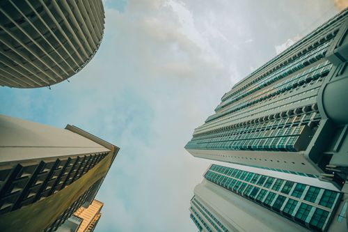 Free Low angle view of modern skyscrapers against a vibrant blue sky. Stock Photo