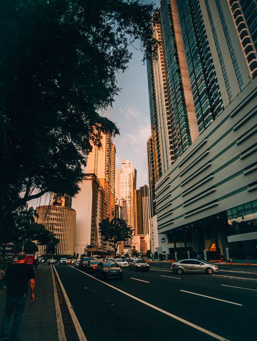 Free Dynamic city view capturing tall buildings and bustling traffic on a sunny day. Stock Photo