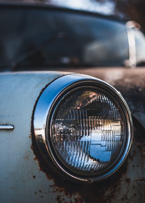 Free Close-up of a rusty vintage car's headlight showing corrosion and age. Stock Photo