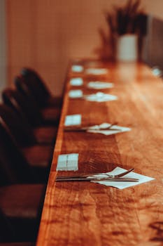 Beautifully arranged cutlery on a wooden bar in a Tokyo restaurant, ready for service.