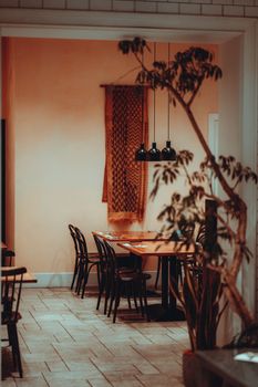 Warm ambiance of a restaurant in Tokyo with empty seats and decorative elements.