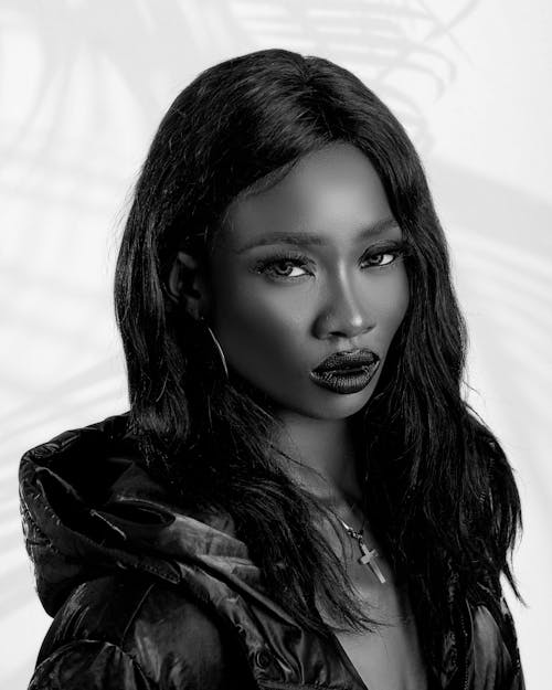 Black and White Photo of a Young Woman in Glamour Makeup and a Jacket 