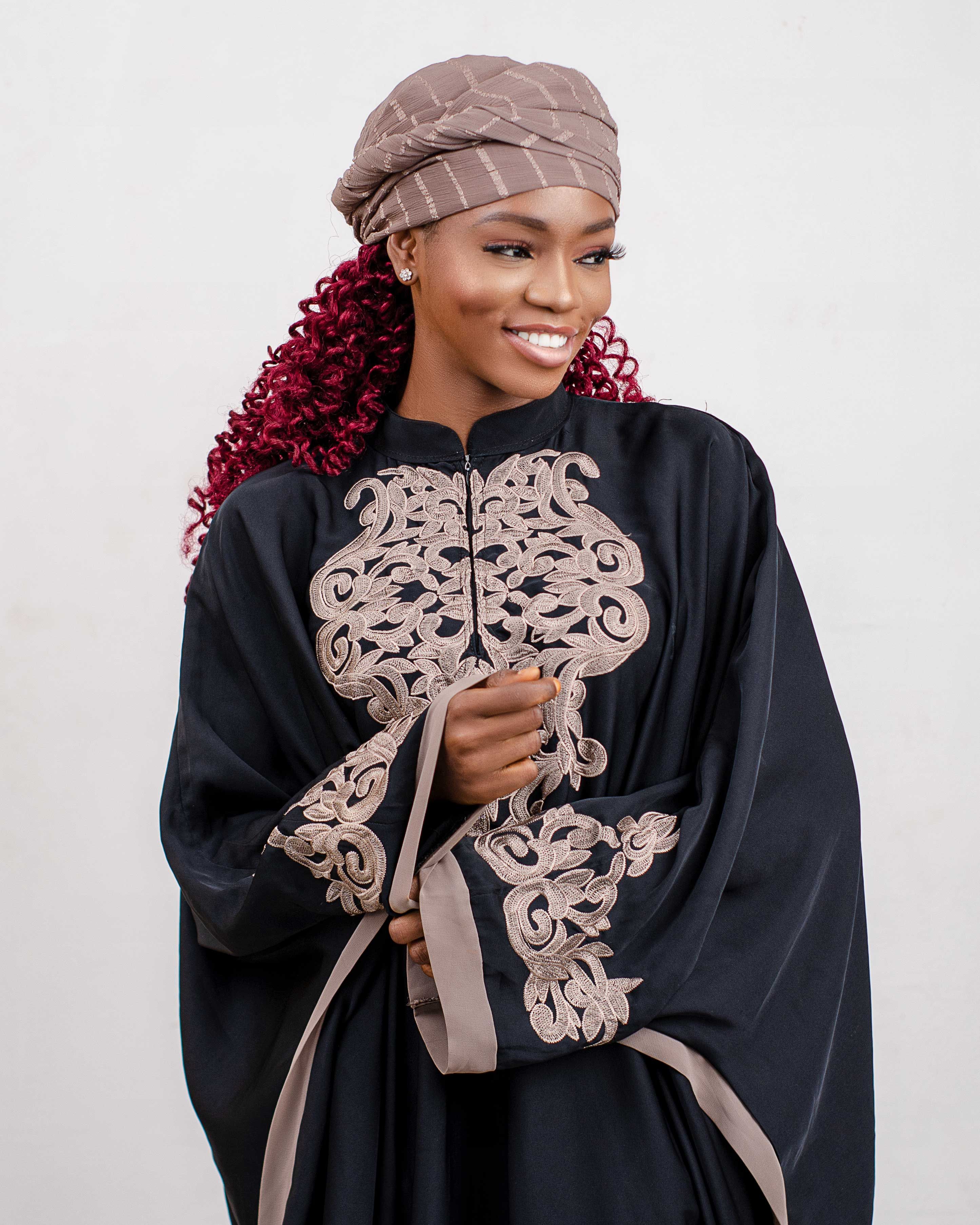 Smiling woman in a beautiful traditional outfit with intricate embroidery, capturing a stylish and cultural look.