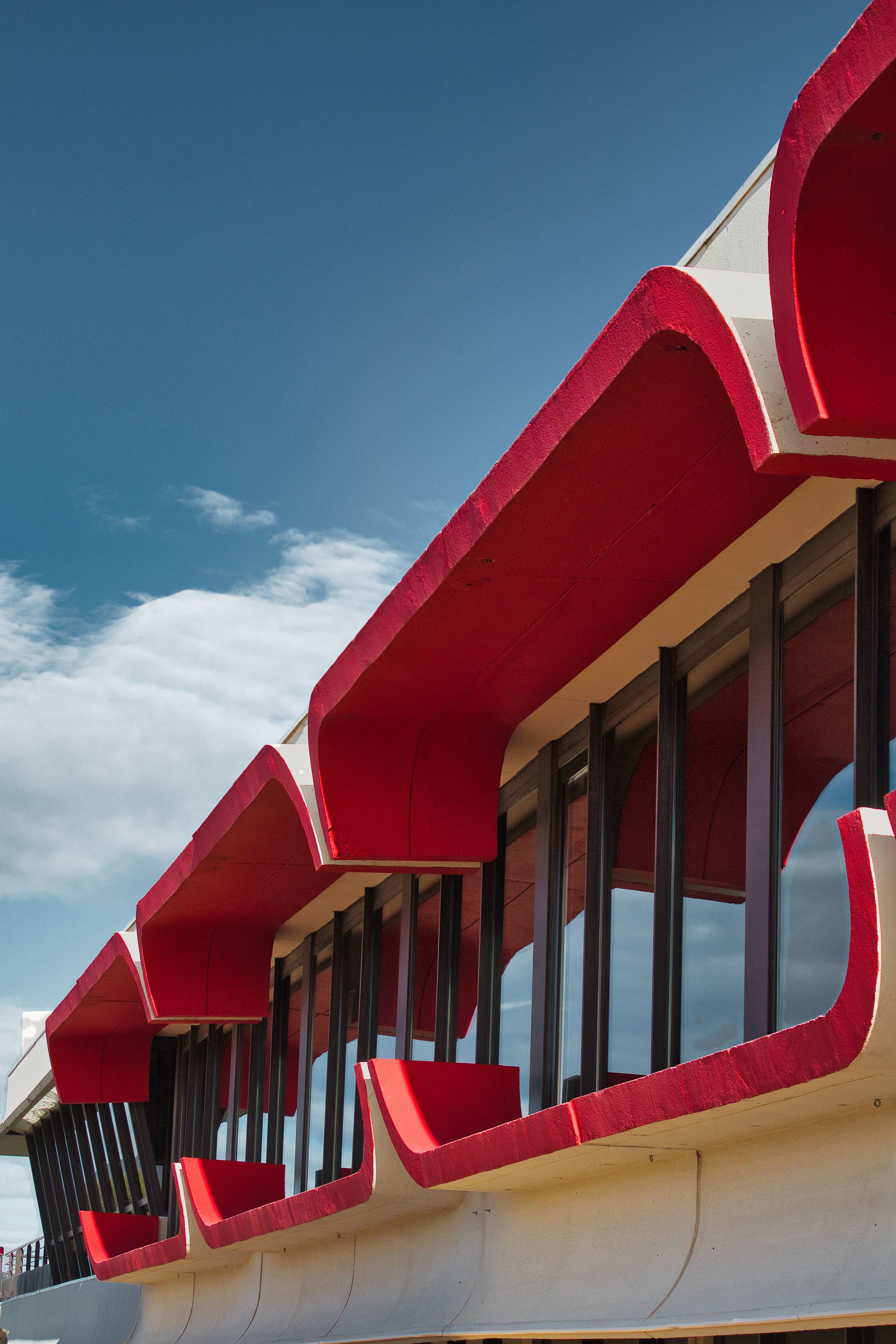 Facade of a Building with Reflective Windows and Red Elements · Free ...