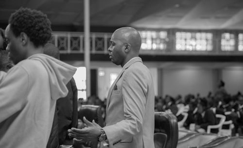 Free A black and white photo capturing people praying during a church service. Stock Photo