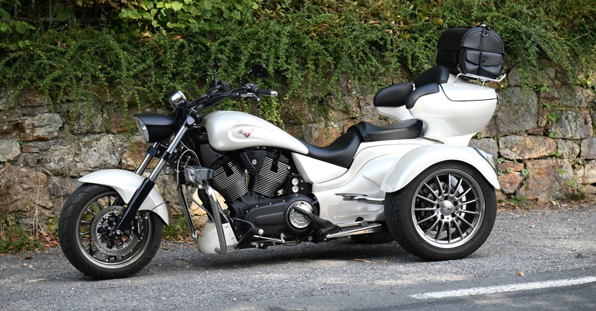 White Moto Rides White Motorbike by the Street · Free Stock Photo