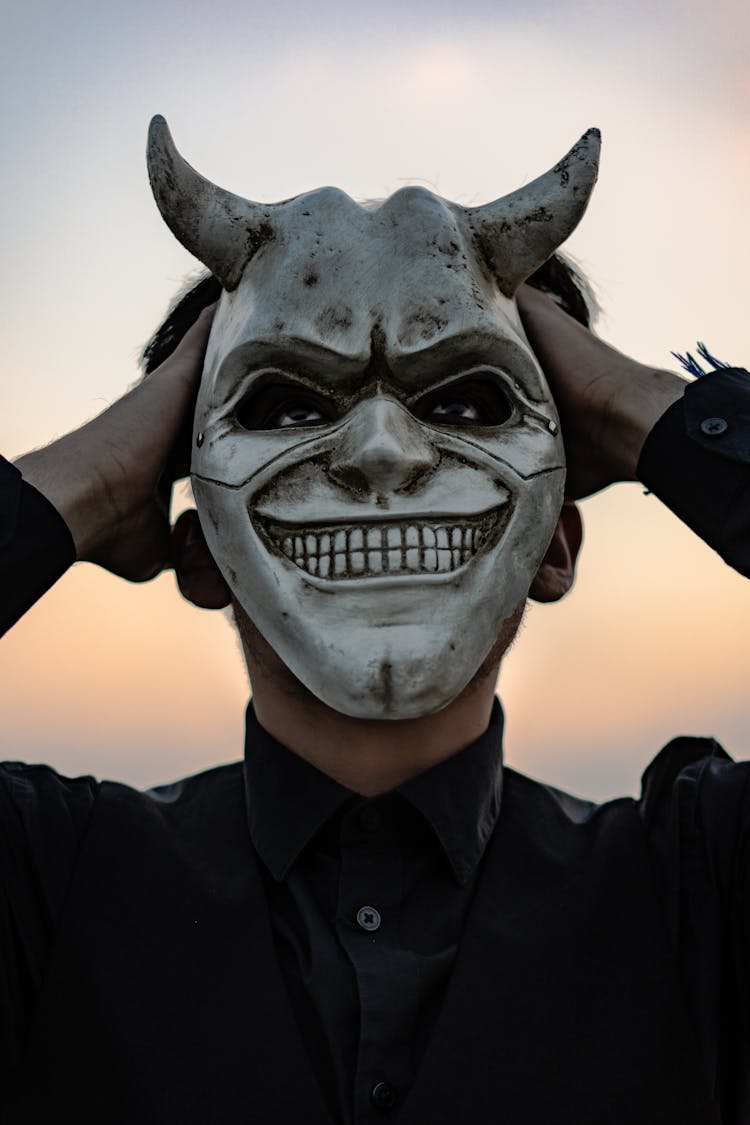 Portrait Of Man Wearing Devil Mask