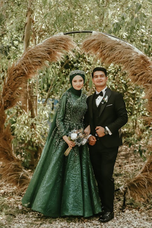 Bride in a Traditional Dress and Groom Standing Outside 