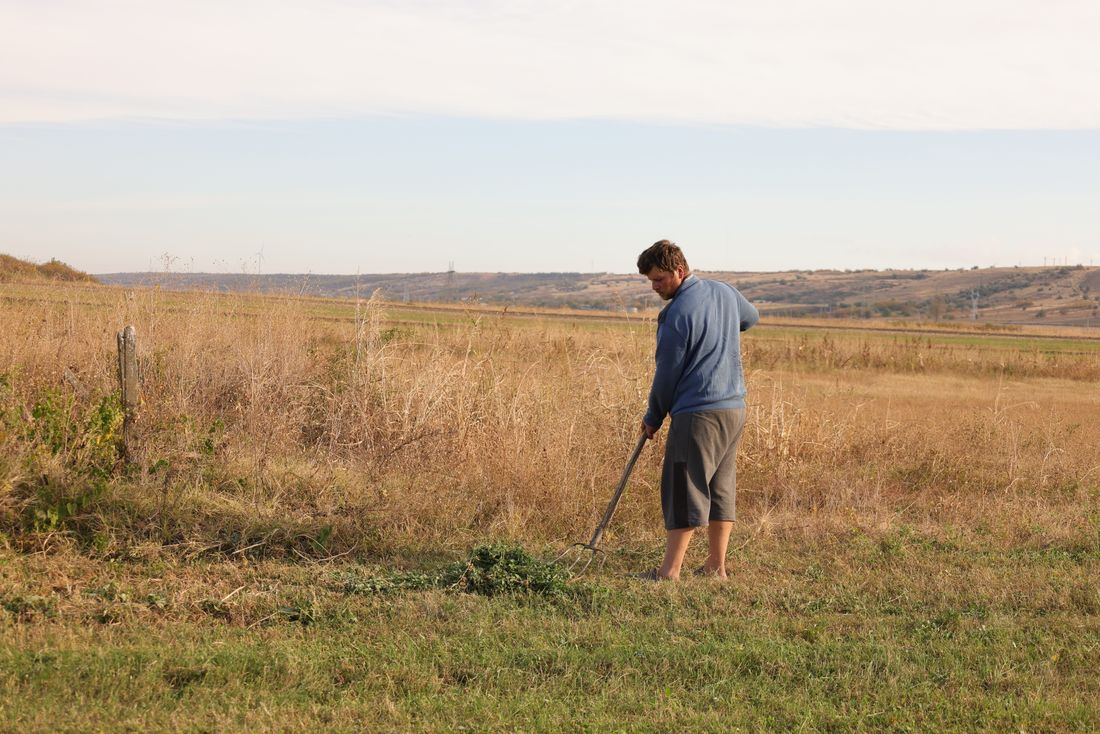 A farmer tending cultivated land outdoors