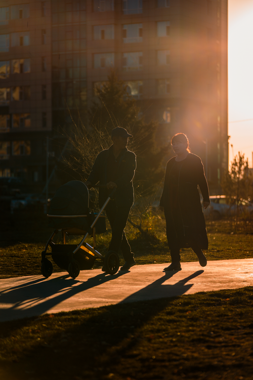 Free Silhouette of a couple walking with a stroller at sunset in Ulaanbaatar, Mongolia. Stock Photo