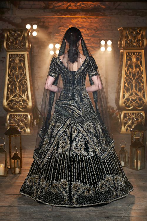 Free Stunning black and gold bridal gown with intricate details and veil. Captured in a luxurious setting, perfect for fashion inspiration. Stock Photo