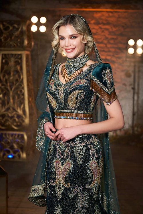 Free Stunning model in traditional bridal dress with intricate gold embroidery. Stock Photo