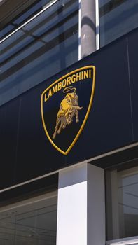 Vertical shot of a Lamborghini sign on a dealership building exterior. 18860917