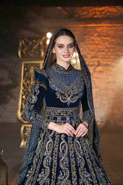 Free Woman in ornate traditional gown with intricate embroidery, indoors portrait. Stock Photo