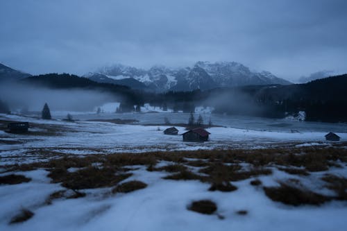 Stream in a Mountain Valley Covered with Snow 