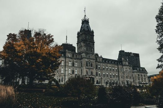 A stunning view of the Quebec City Parliament Building surrounded by autumn foliage.