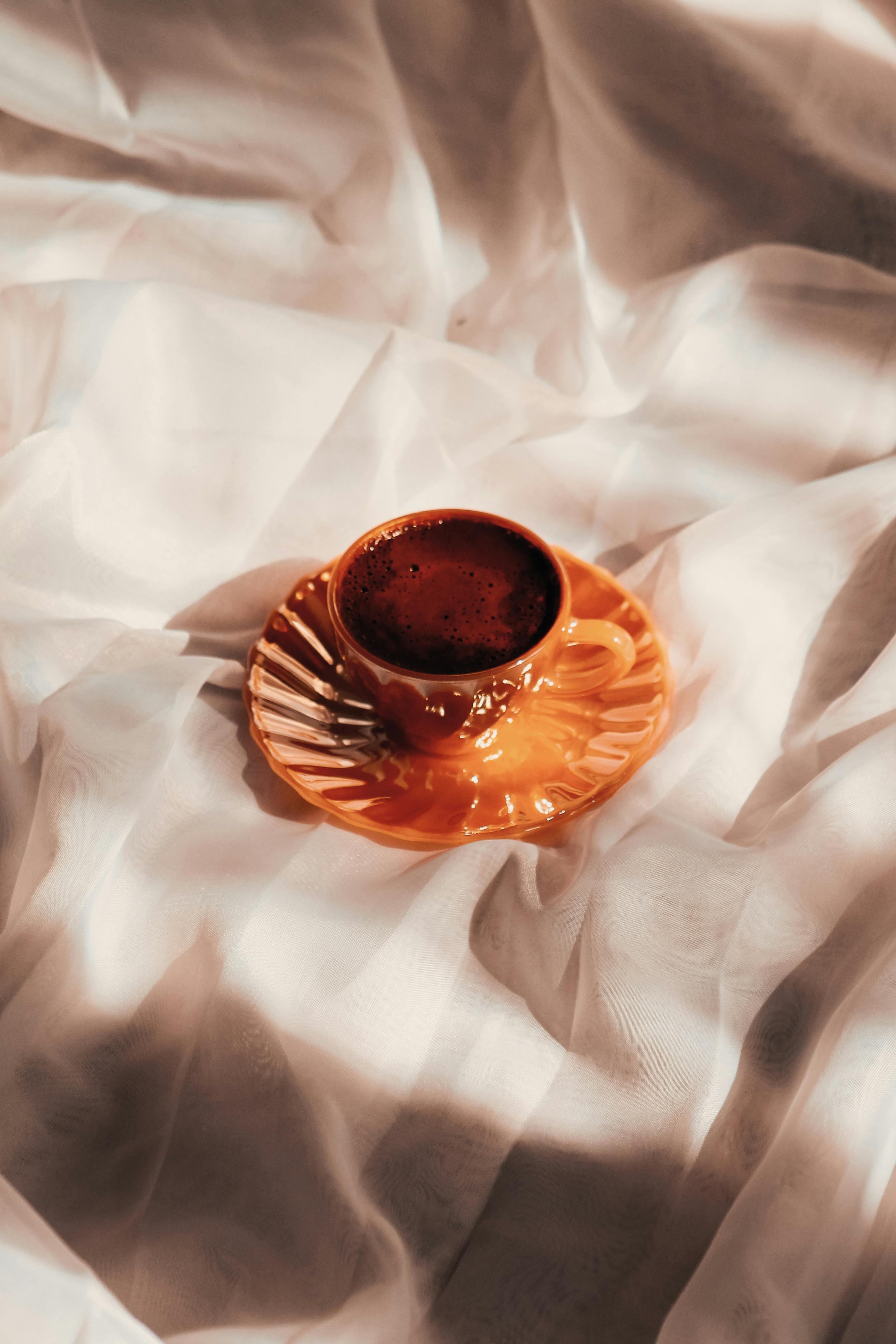 Aesthetic coffee setup on delicate fabric for a cozy morning vibe.
