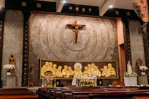 Crucified Jesus Christ over Golden Reliefs on Altar in Church