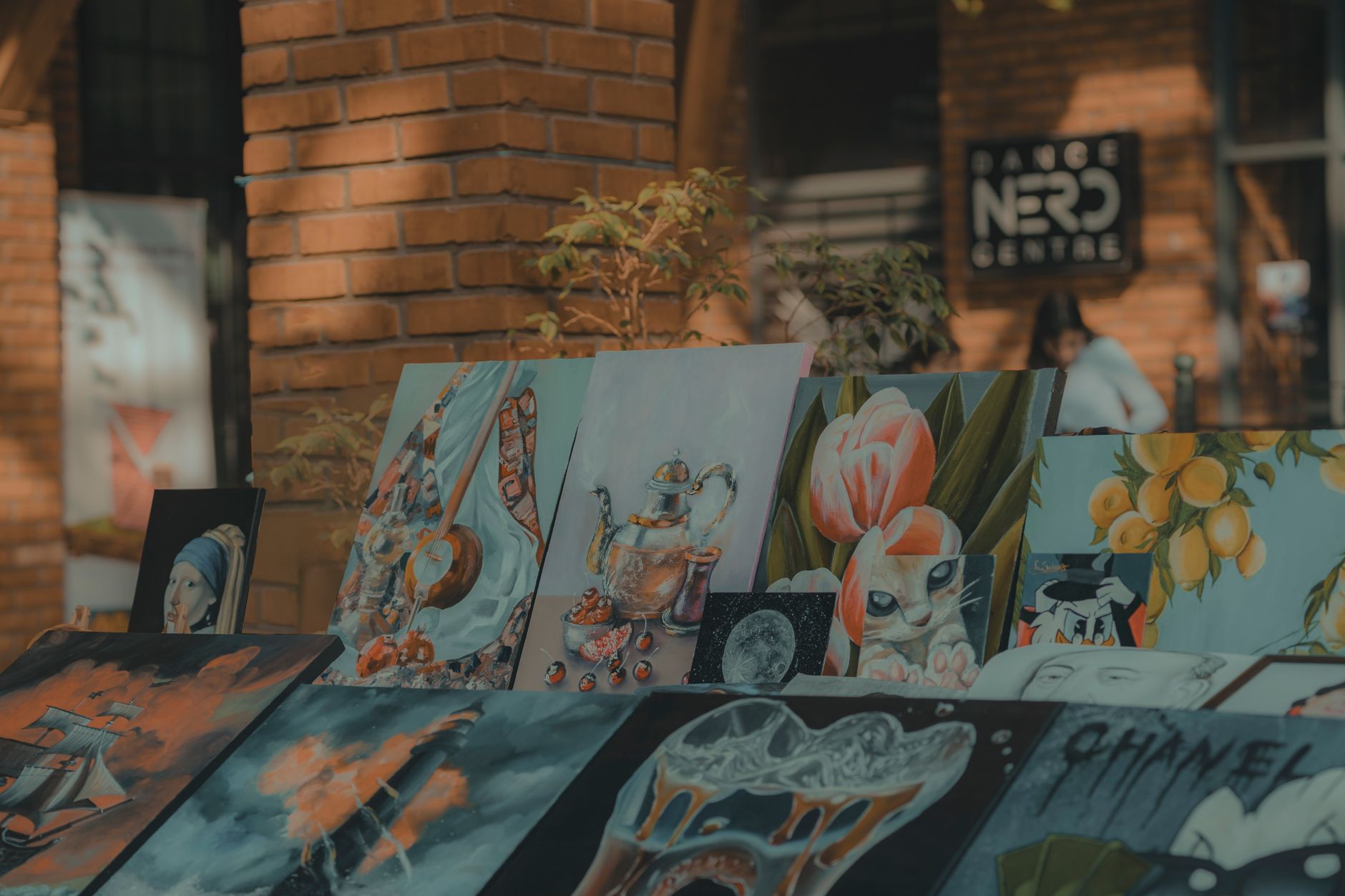 A lively display of colorful paintings in an outdoor urban art exhibition, capturing creativity.