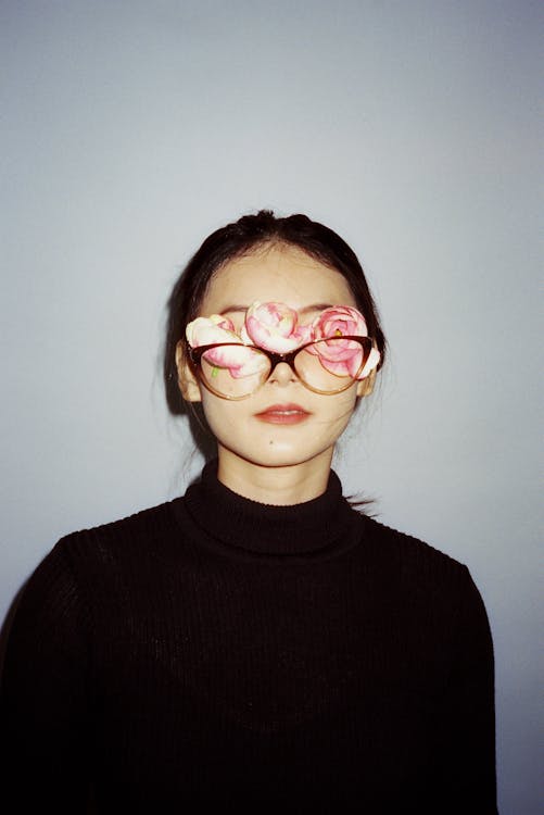Woman with Flowers behind Eyeglasses