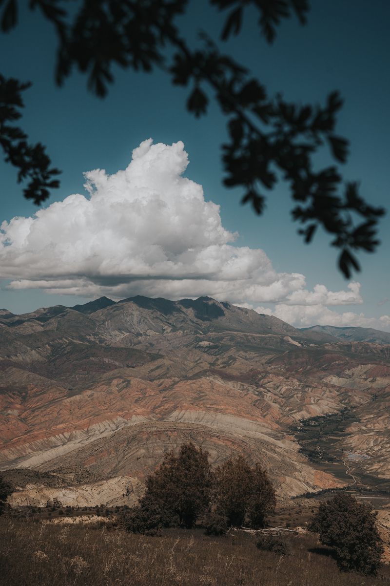 Breathtaking view of mountains and valleys in Erzincan, Türkiye under a dramatic sky.