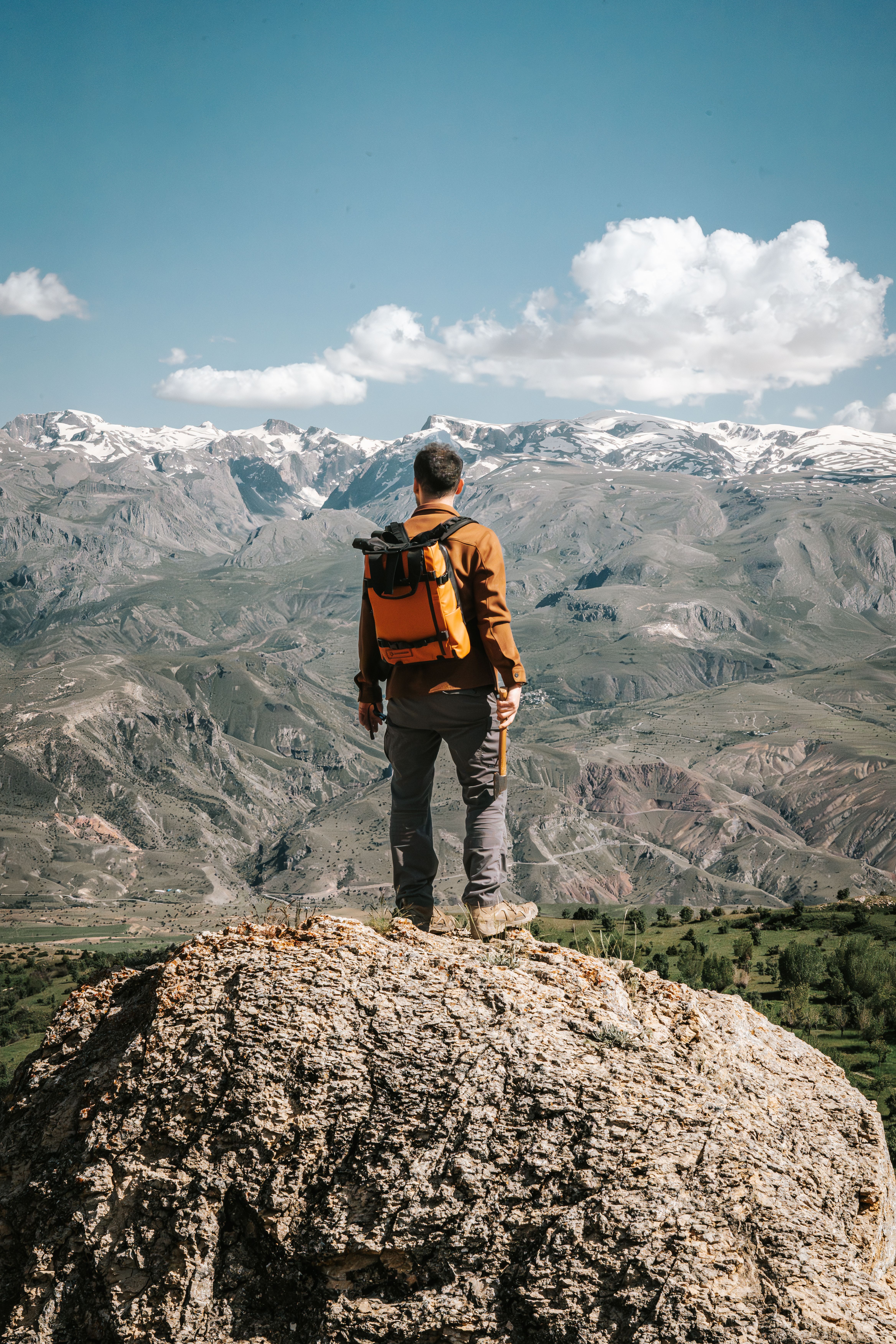 Man Standing on a Rock and Looking at the Mountains · Free Stock Photo