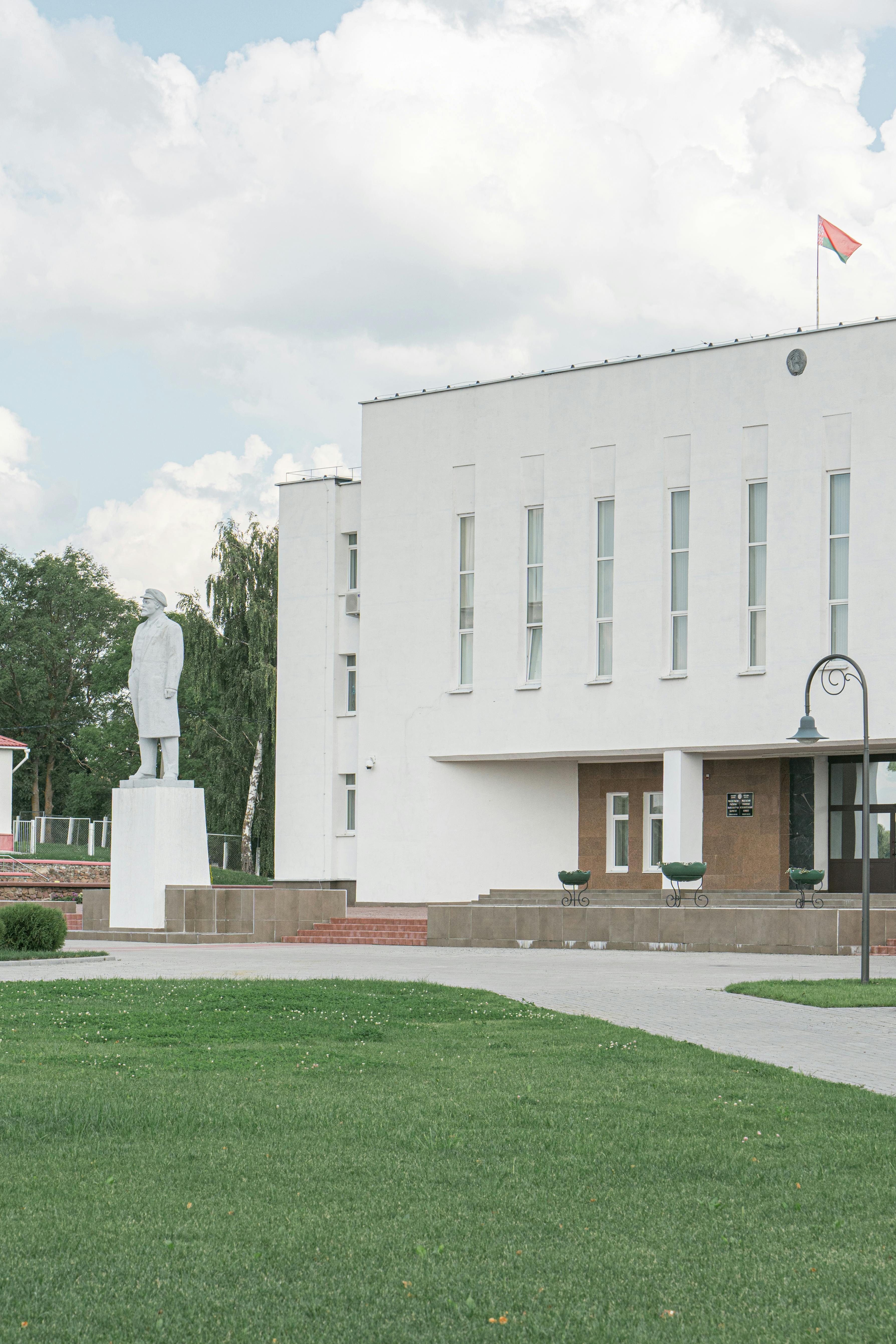A stylish urban shot of an elegant modern building and statue in Myadel, Belarus.